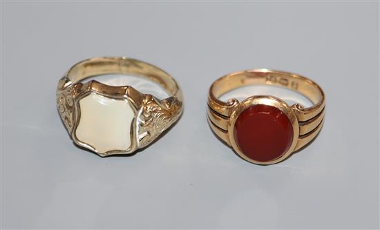 A Victorian 18ct gold and carnelian signet ring and a similar yellow metal ring.